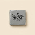 A single wrapped Faber-Castell Knetgummi Art Eraser, model 127020, shown on a solid light beige background.