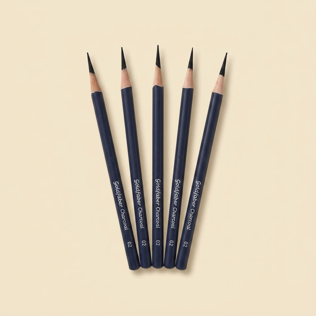 Five dark blue graphite pencils with black tips and natural wood barrels, arranged in a fan shape on a light beige background. The pencils are labeled 'Spidelfabel Charcoal 02'.
