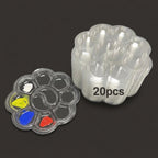 A stack of 20 clear plastic flower-shaped cup holders with one cup holder shown open and filled with small paint wells in yellow, blue, red, and white, on a dark gray background.