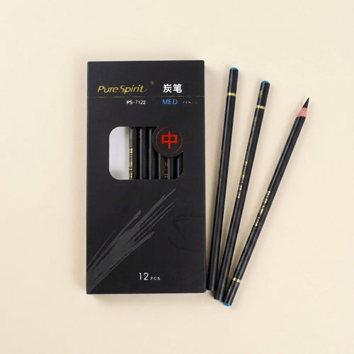 Pure Spirit 12-piece charcoal pencil box with three pencils fanned beside it
