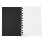 Black spiral-bound sketchpad with white pages on a white background