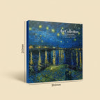 A square art print or canvas shown at an angle on a beige background, featuring a blue-toned impressionistic night scene with stars, water reflections, and small city lights. White text on the artwork reads 'Art Collection.