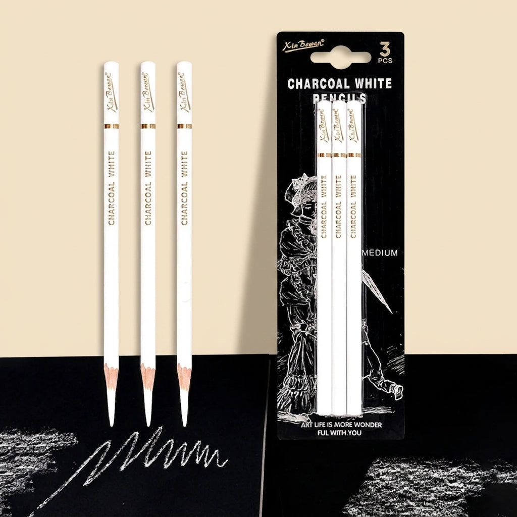 Three Xin Bowen white charcoal pencils standing upright beside their retail blister pack, on a beige and black background
